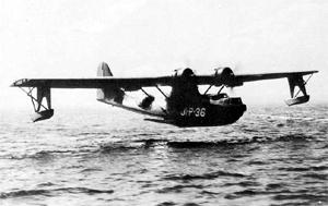 PBY-5 из тренировочного подразделения в Джексонвилле взлетает для выполнения учебного бомбометания. Антенна радиополукомпаса на центроплане между мотогондолами хорошо заметна на фоне неба. На бомбодержателях под крыльями подвешены четыре бомбы